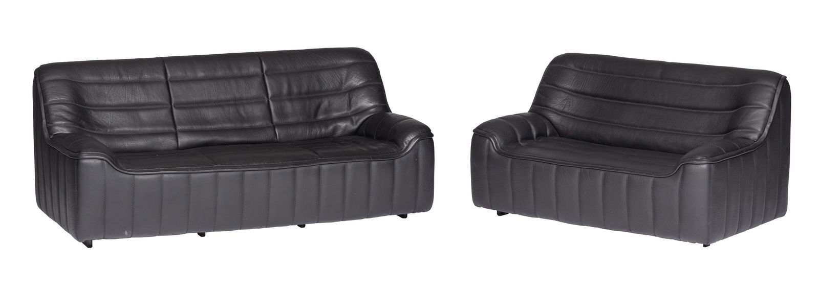 A set of two '70s design black buffalo leather DS84: A set of two '70s design black buffalo leather DS84 settees by De Sede, consisting of a two-seater and a three-seater, H 80 - W 142 - 187 - D 85 cm