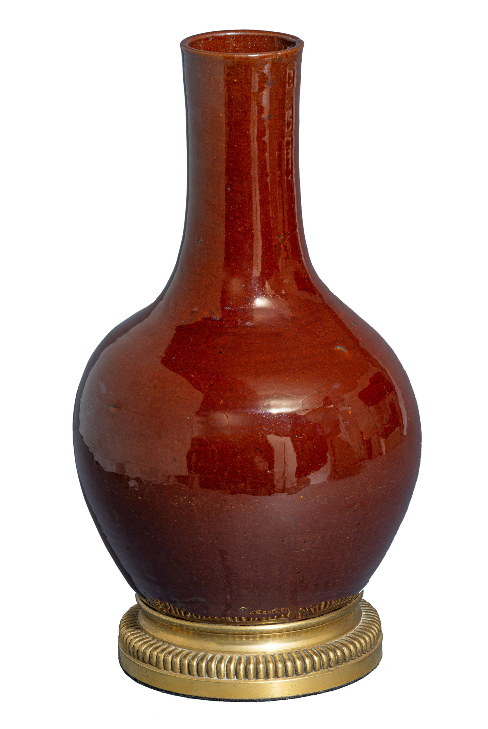 A Chinese sang-de-boeuf bottle vase, with a gilt: A Chinese sang-de-boeuf bottle vase, with a gilt bronze mount to the base, H 34 cm A Chinese sang-de-boeuf bottle vase, in deep oxblood-red glaze, with a gilt bronze mount to the base, H 34 cm