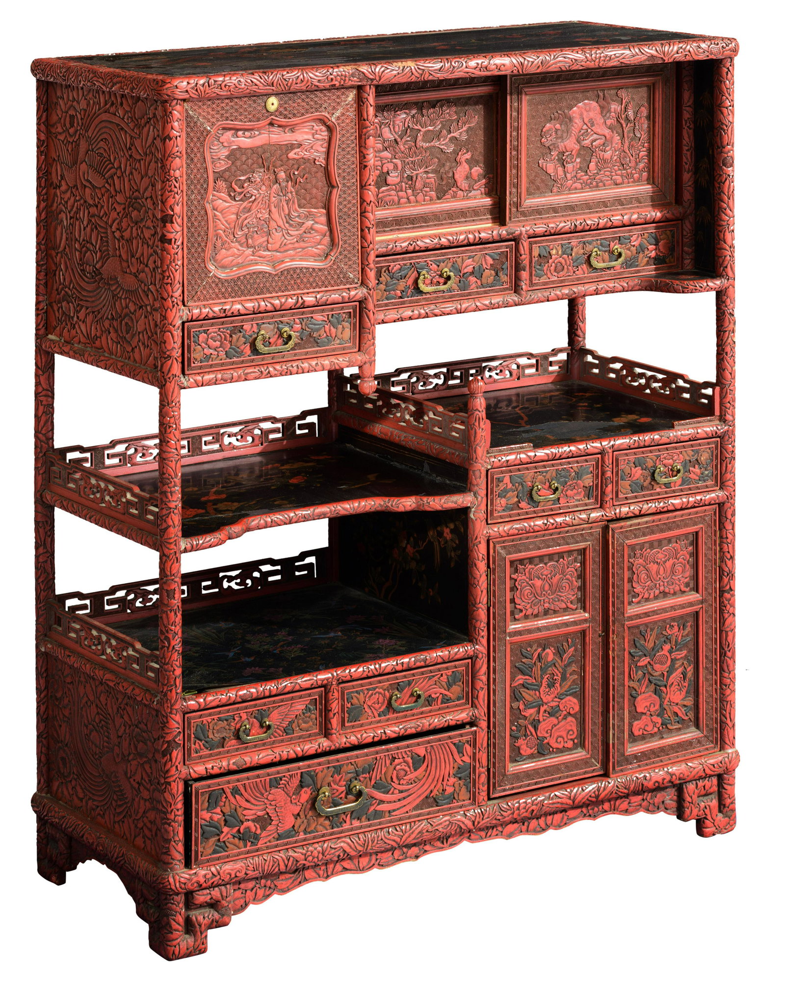 A Chinese carved cinnabar red lacquered cabinet, late: A Chinese carved cinnabar red lacquered cabinet, late 19thC/early 20thC, H 103 cm A Chinese carved cinnabar red lacquered cabinet, with black lacquered tops/shelves, late 19thC/early 20thC, H 103 - W 
