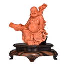 A Chinese red coral figure of a prosperous smiling Budai, late Qing, H 19 - W 16,1 cm - Weight 809 g