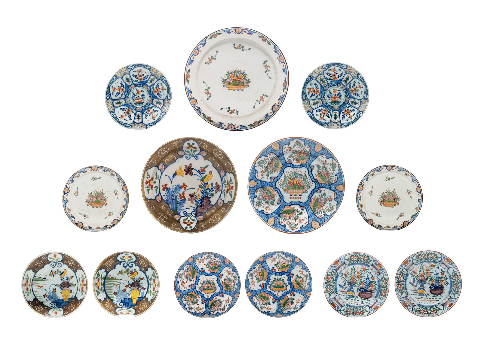 A various collection of thirteen 18thC Delft chargers and plates, ø 22 - 34,5 cm (1 of 17)