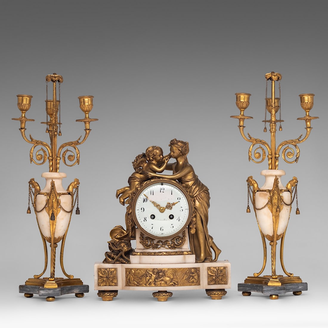 A pair of Louis XVI period candelabras and a matching Napoleon III mantle clock, H 32 - 46,5 cm: A pair of Louis XVI period candelabras and a matching Napoleon III mantle clock, H 32 - 46,5 cm A pair of Louis XVI period Carrara marble and gilt bronze candelabras, late 18thC, H 46,5 cm A Napoleon 