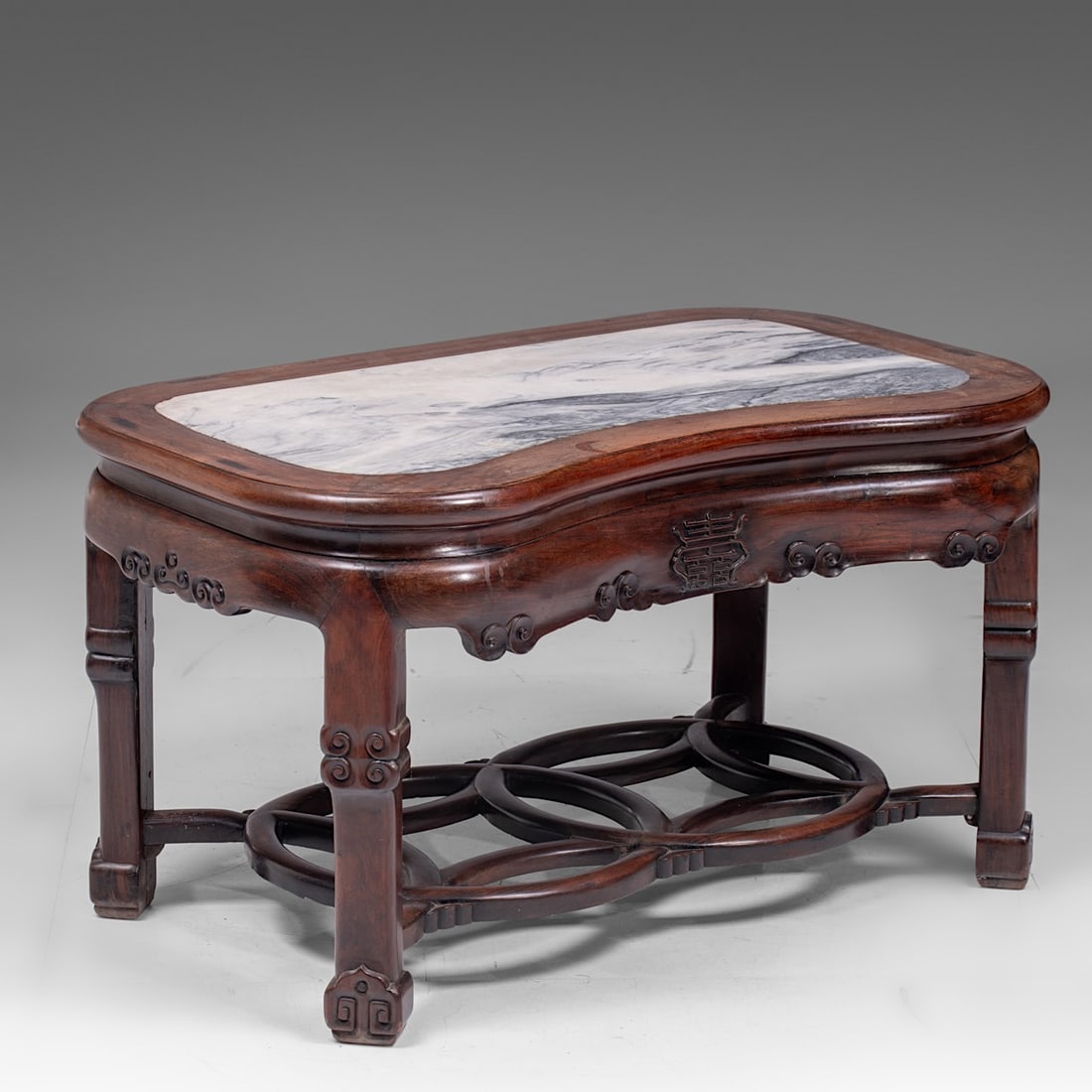 A Chinese hardwood low table, with marble plaque, late Qing, H 51,5 - L 92 - D 57 cm: A Chinese hardwood low table, with marble plaque, late Qing, H 51,5 - L 92 - D 57 cm A Chinese hardwood low table, with marble plaque, finely carved with high-lief details including the double-Xi char