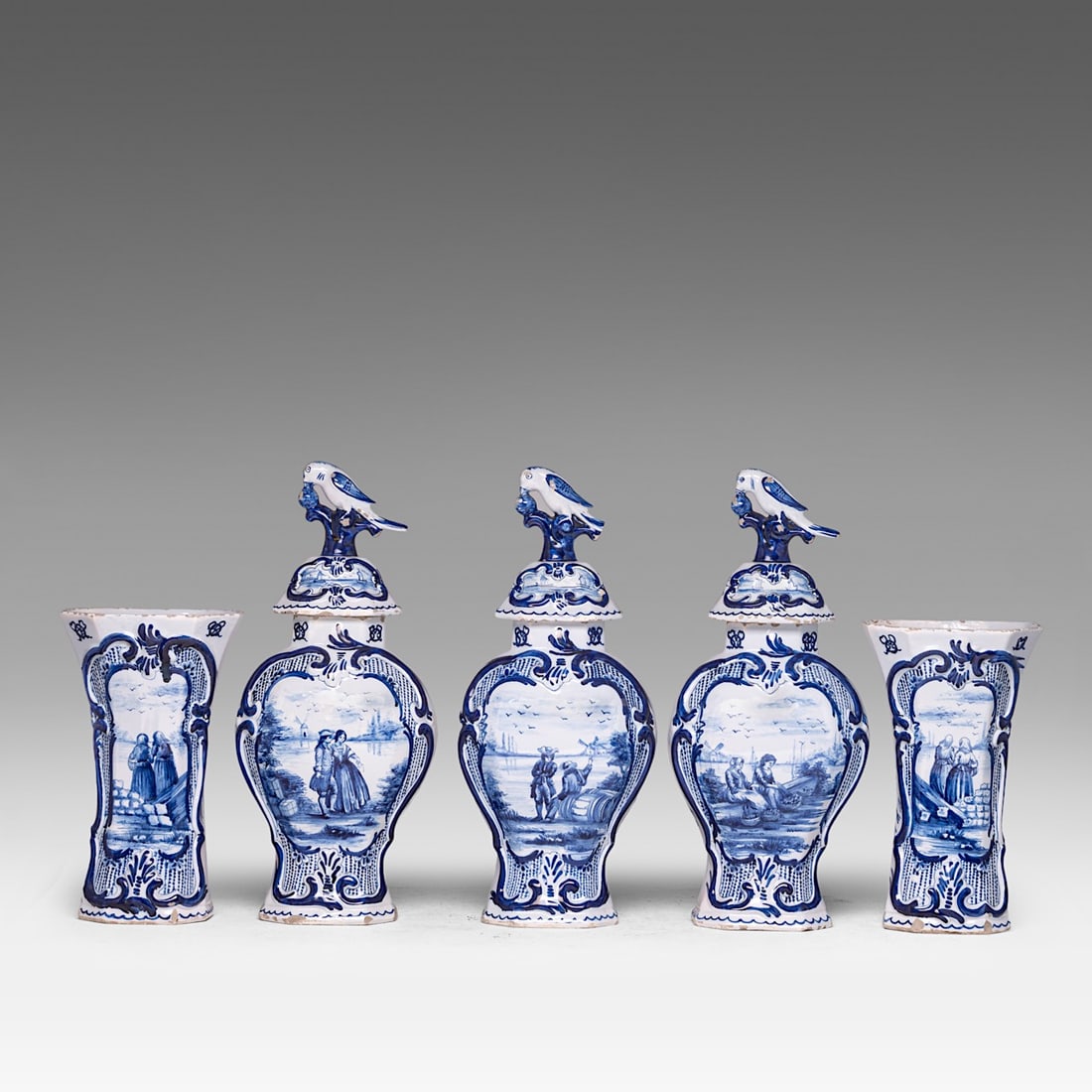 A five-piece blue and white Dutch Delft garniture set, signed Johannes Van Duijn, H 25 - 37 cm: A five-piece blue and white Dutch Delft garniture set, signed Johannes Van Duijn, H 25 - 37 cmSigned Johannes Van Duijn, owner of the manufactory 'De Porceleyne Schotel' between 1764 and 1772.