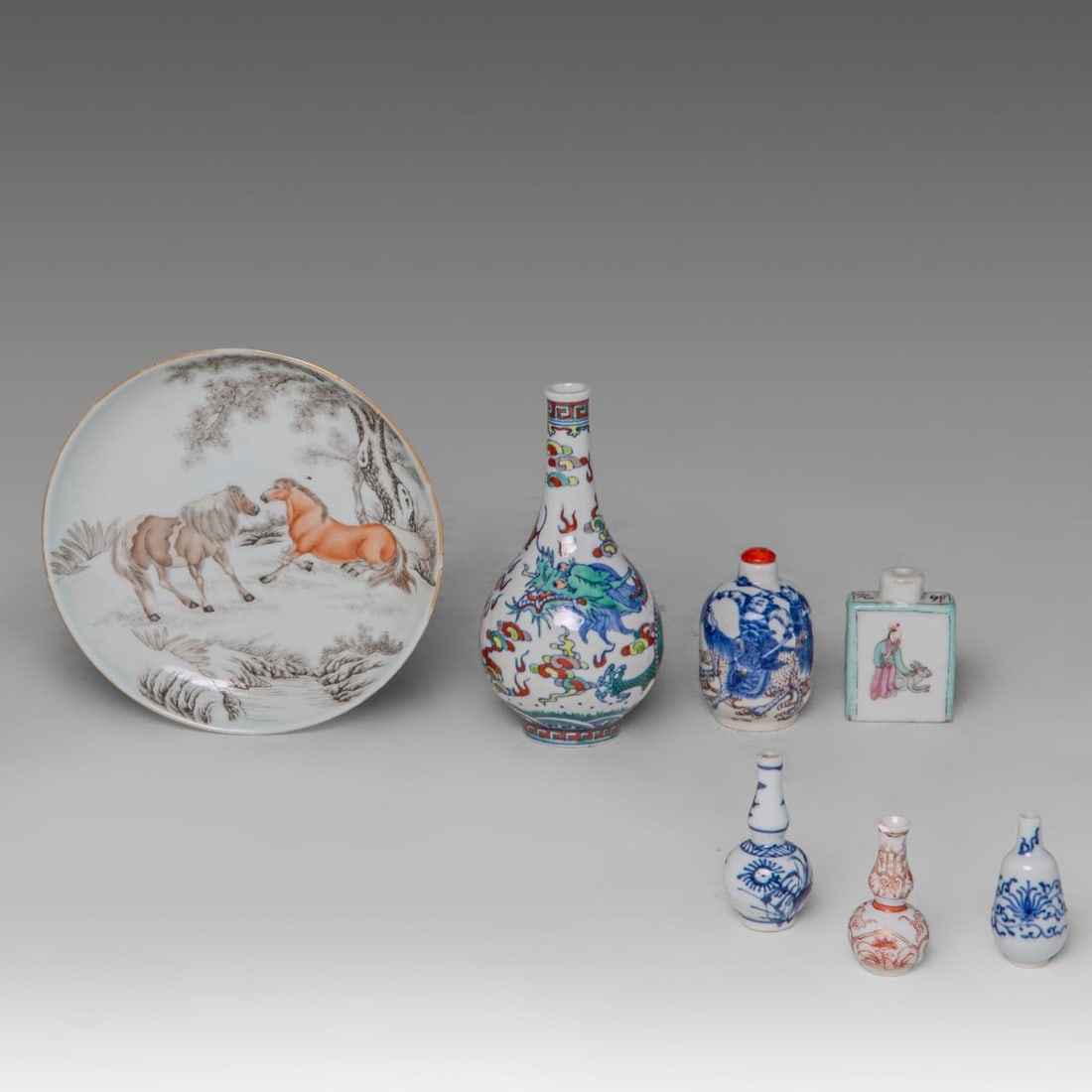 A small collection of various Chinese porcelain ware, including a doucai 'Dragon' vase, and a: A small collection of various Chinese porcelain ware, including a doucai 'Dragon' vase, and a copper-red snuff bottle, some marked, late 19thC/ Republic period, tallest H 15 cm Comprises: A Chinese ir