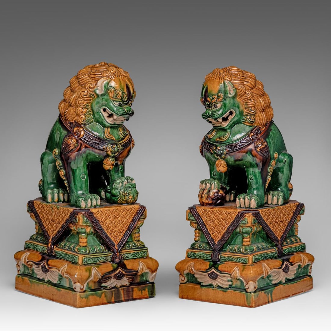A pair of Chinese sancai glazed models of Buddhist lions, 20thC, H 45 - 44,5 cm: A pair of Chinese sancai glazed models of Buddhist lions, 20thC, H 45 - 44,5 cm A pair of Chinese sancai glazed models of Buddhist lions, 20thC, H 45 - 44,5 cm