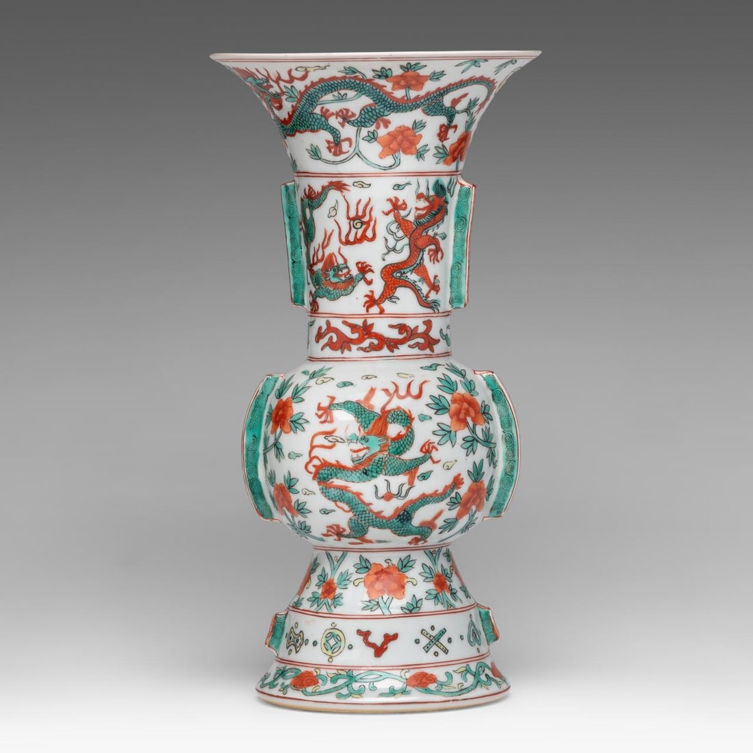 A Chinese Wucai style 'Dragon' gu vase, with a Wanli mark, late 19thC/20thC, H 35,2 cm: A Chinese Wucai style 'Dragon' gu vase, with a Wanli mark, late 19thC/20thC, H 35,2 cm A Chinese Wucai style 'Dragon' gu vase, all over decorated with dragons amongst flower branches in iron-read, gre