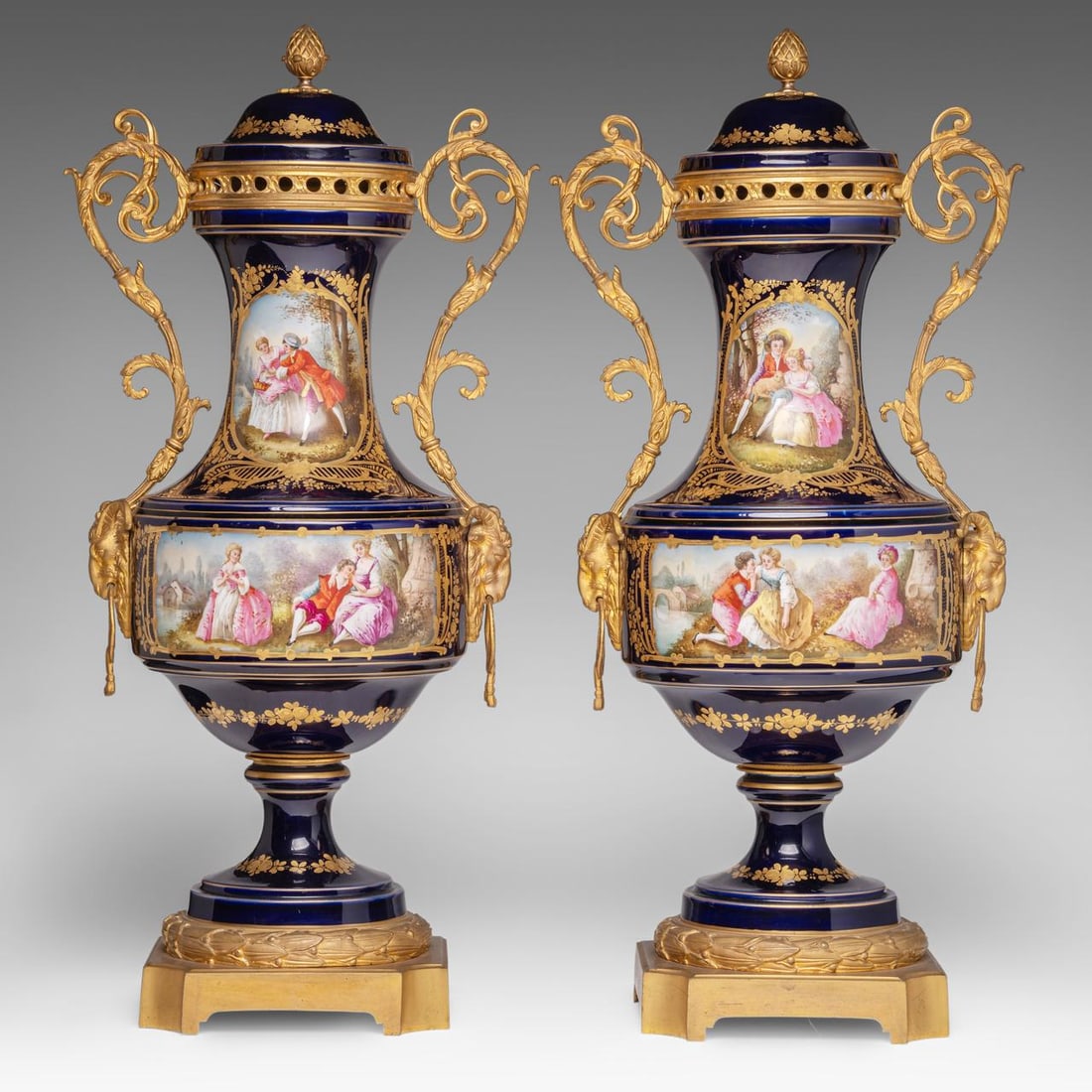 A pair of blue royale ground Sevres vases with hand-painted gallant scenes and gilt bronze mounts, H: A pair of blue royale ground Sevres vases with hand-painted gallant scenes and gilt bronze mounts, H 65 cm The inside of the covers marked, the hand-painted roundels signed to the lower right corner.