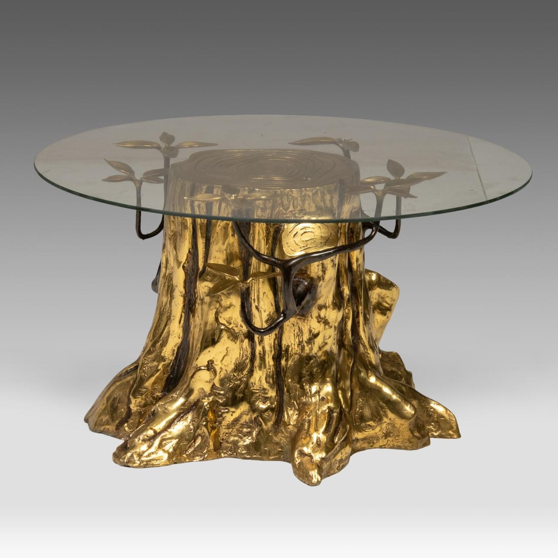 A gilt brass tree coffee table with a glass top designed by Willy Daro, 1970's: A gilt brass tree coffee table with a glass top designed by Willy Daro, 1970's