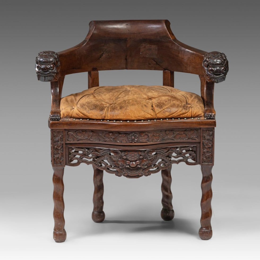 A Chinese hardwood arm chair, presumably padouk or shunzhi, Qing, total H 81,5 - W 69,5 cm: A Chinese hardwood arm chair, presumably padouk or shunzhi, Qing, total H 81,5 - W 69,5 cm A Chinese hardwood arm chair, presumably padouk or shunzhi, the frieze open-work carved with a dragon head, t