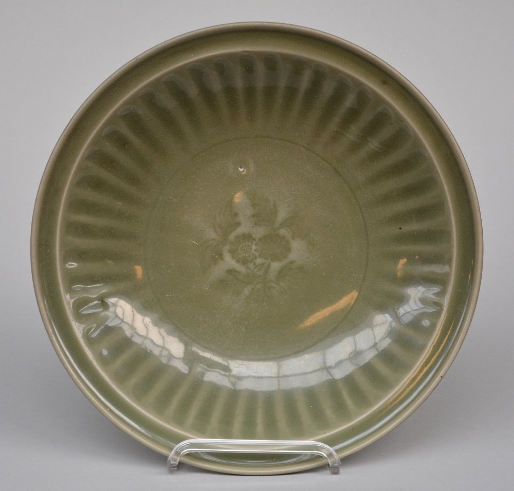 A Chinese celadon plate with flowers relief decoration, (1 of 2)
