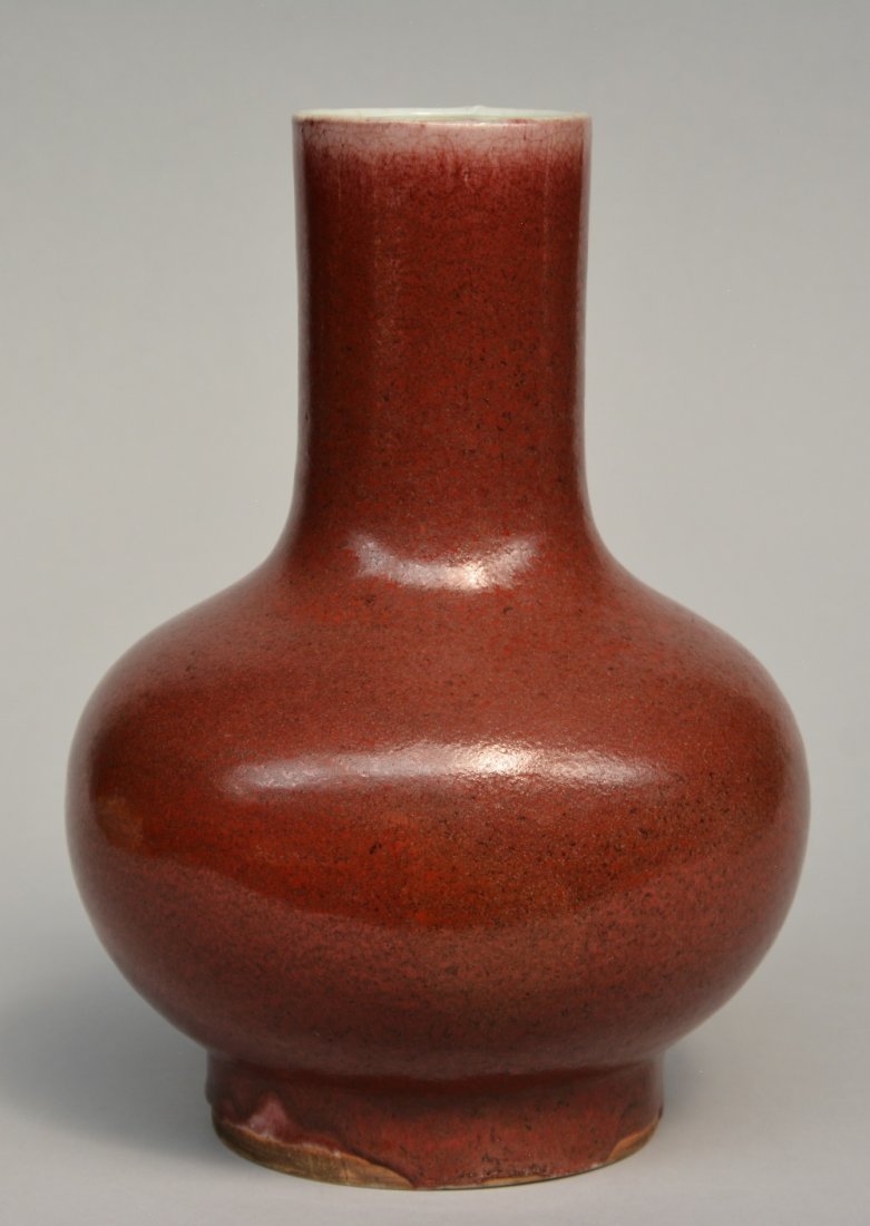 A Chinese monochrome iron-red glazed bottle vase, (1 of 8)