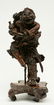 A Chinese walnut carved sculpture depicting a mythical