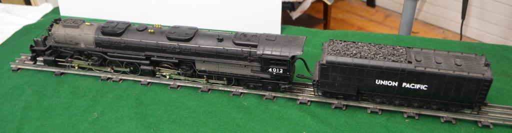 MTH Big Boy Steam Engine 4-8-8-4 Locomotive: Mike's Train House Big Boy Steam Engine and Tender. Union Pacific. No. 4012. Rail King. O Gauge. Included in this lot are four freight cars pictured.