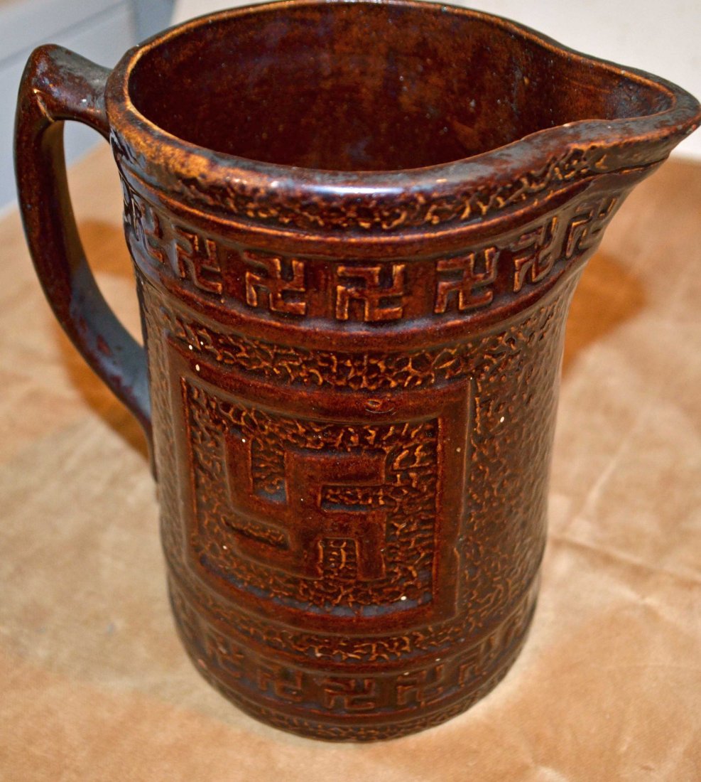 Antique Native American Stoneware Pitcher with Swastika: Antique Native American Stoneware Pitcher with Swastika Design. Salt-Glazed Brown Stoneware Pitcher. The Swastika Emblem appears throughout the pitcher. The swastika pitcher was commonly used by early