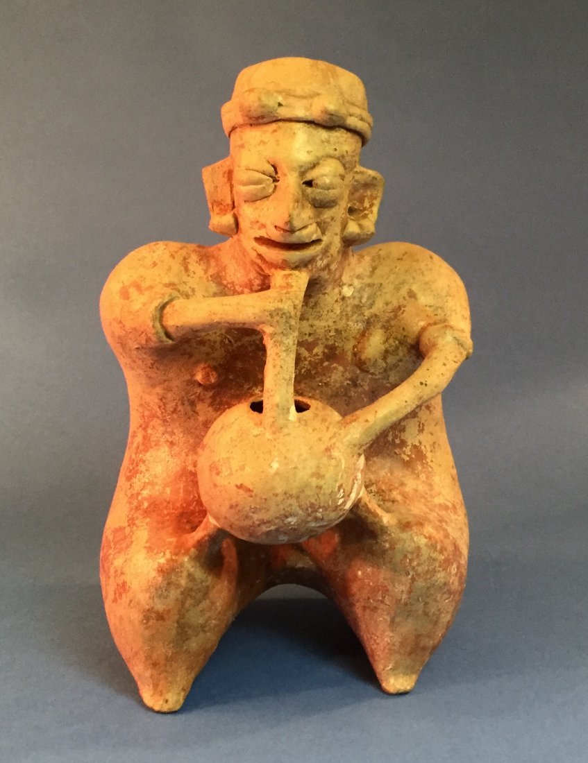 Pre-Columbian Pottery Figure: Pre-Columbian Pottery Figure, appears to be smoking from a gourd. Item measures approximately 9.5" x 6".