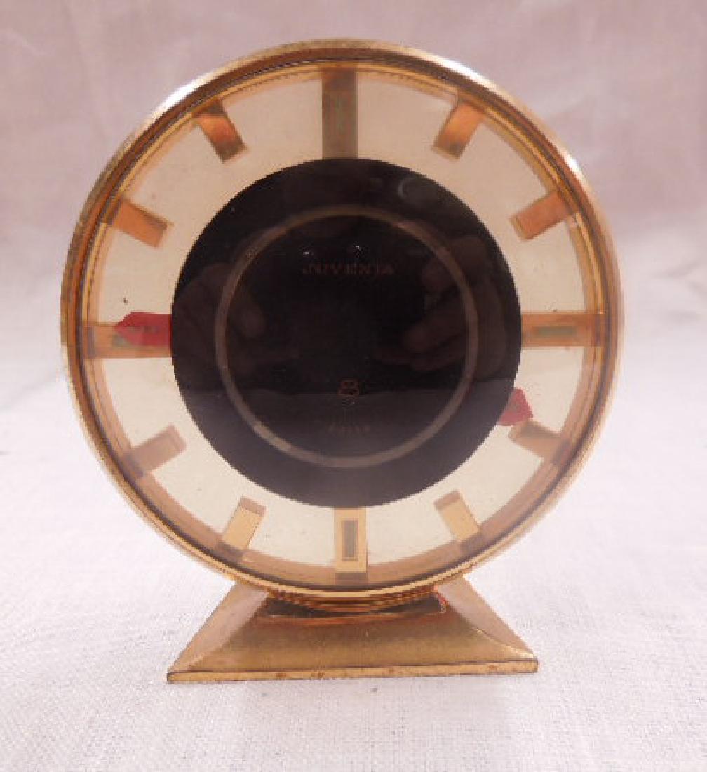 1950's Juvenia 8 Day Travel Alarm Clock: Circa 1950's Swiss brand Juvenia brass and glass cased 3 1/2" (h) x 3" (l) 8 day travel alarm clock. CONDITION: Non-working condition with patina wear on case.