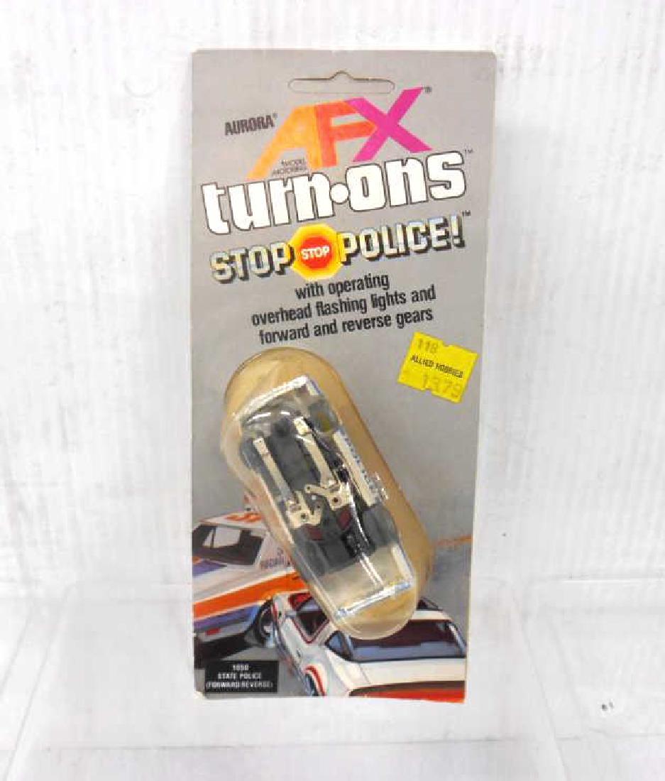 Aurora AFX Turn-Ons State Police Slot Car: Vintage Aurora AFX Turn-Ons No. 1050 Stop Police State Police slot car, packaged in Canada. CONDITION: New in packaging, but upside down under plastic.