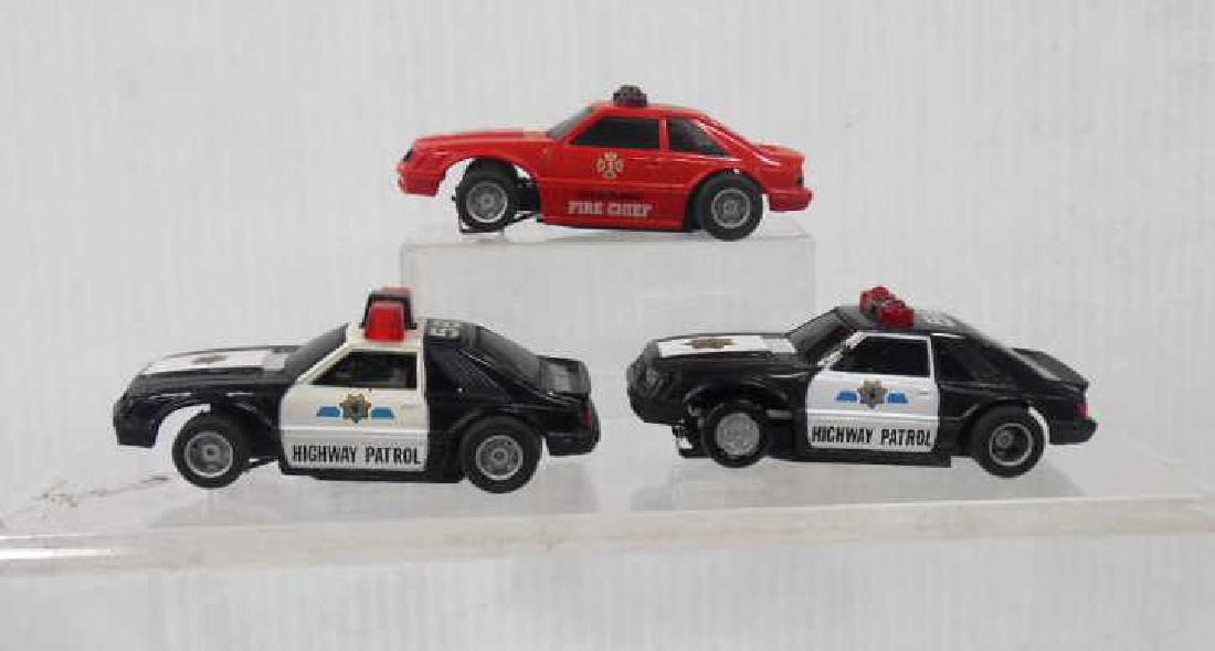 Tyco AFX Fire Chief & Police Car Slot Cars: Tyco AFX Mustang Fire Chief & (2) Police Car slot cars. CONDITION: Untested used condition with minor wear.
