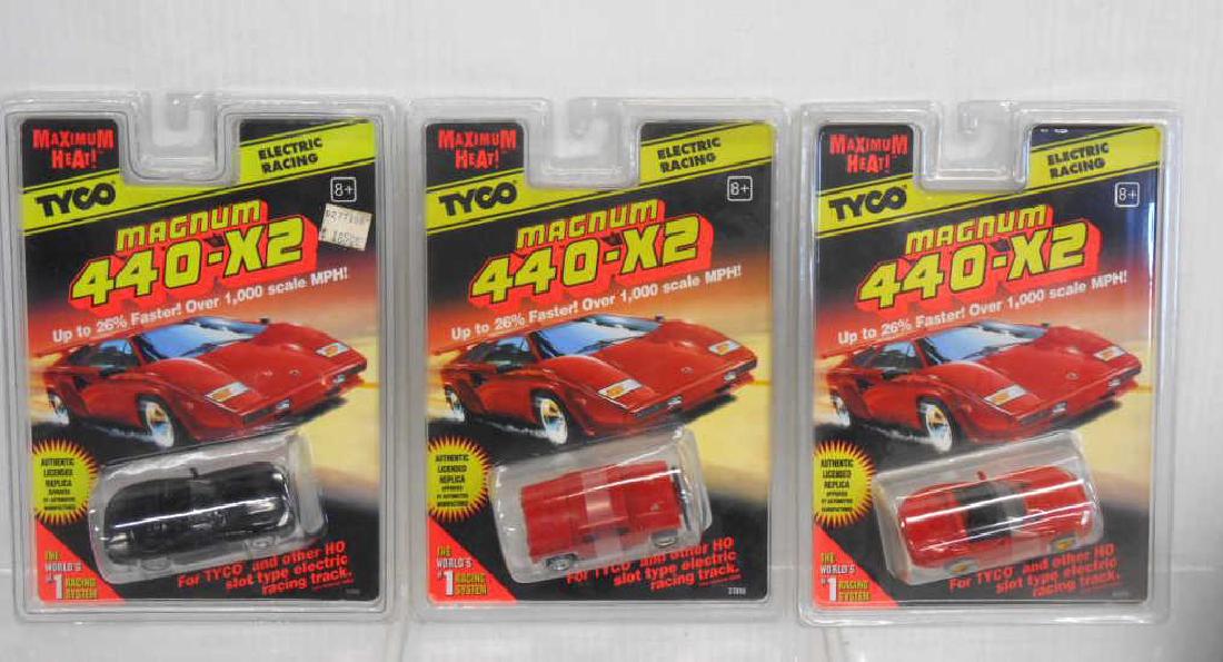 Tyco Magnum 440-X2 Slot Cars: Three assorted Tyco Magnum 440-X2 slot cars, includes: red Hummer, red Viper & black Corvette, circa 1996. CONDITION: All are new in their original packaging.