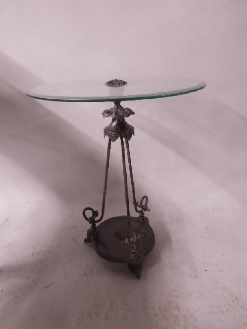 Renaissance Revival Style Tabouret: Renaissance Revival Style Tabouret, beveled glass top with cast metal center rosette upon a foliate and tripod scrolled rod base on a round platform with scroll feet, 20th C., 20"d, 25" h. CONDITION: 