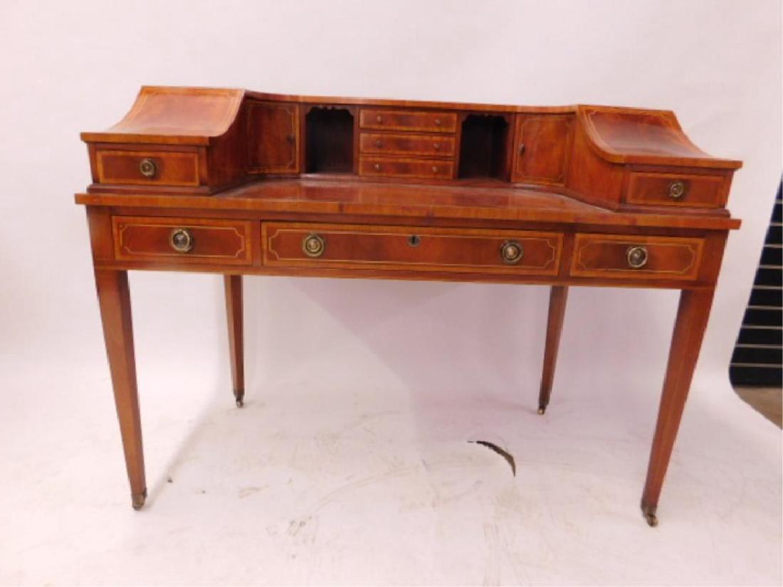 Carlton Style Desk: Carlton Style Desk, mahogany band and line inlays and tooled leather top, the gallery top with three drawers flanked by cubby holes, two doors and concave lids with two drawers; base has three drawers
