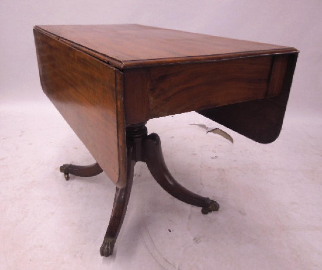 19th C Duncan Phyfe Style Drop Leaf Table: 19th C Duncan Phyfe Style Drop Leaf Table, molded edge 20 1/2" single board top and 12" round edge drop leaves, crushed ball pedestal with four sabre legs having brass lion paw caps and casters, Engli