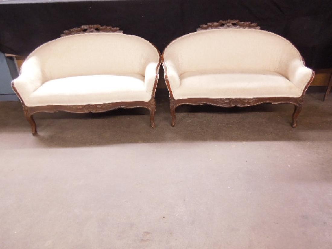 Rococo Revival Love Seats: Pr Rococo Revival Love Seats, walnut, low profile, features floral and acanthus carved crests and carved cabriole legs, brocade ivory cloth upholstery, late 19th C., 44 1/2' l, 30 1/2' h, 15" seat h, 