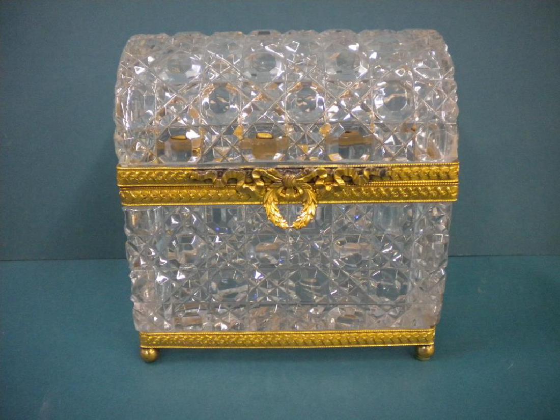Crystal & Dore Brass Casket: Crystal & Dore Brass Casket, waffle pattern crystal with domed hinged lid, cast floral banded dore brass trim, wreath and ribbon pull and ball feet, probably French, mid 20th C., 7" x 7 3/8" x 4 1/2".