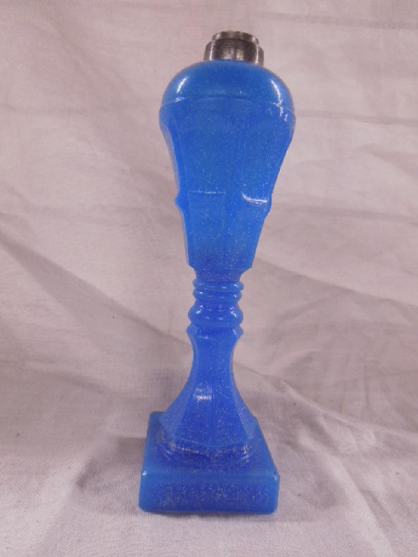 Whale Oil Lamp: Whale Oil Lamp, blue camphor glass, hexagonal paneled font on a ring turned, inverted trumpet column upon a square base, 19th c, 10 1/4" h. CONDITION: No issues identified.
