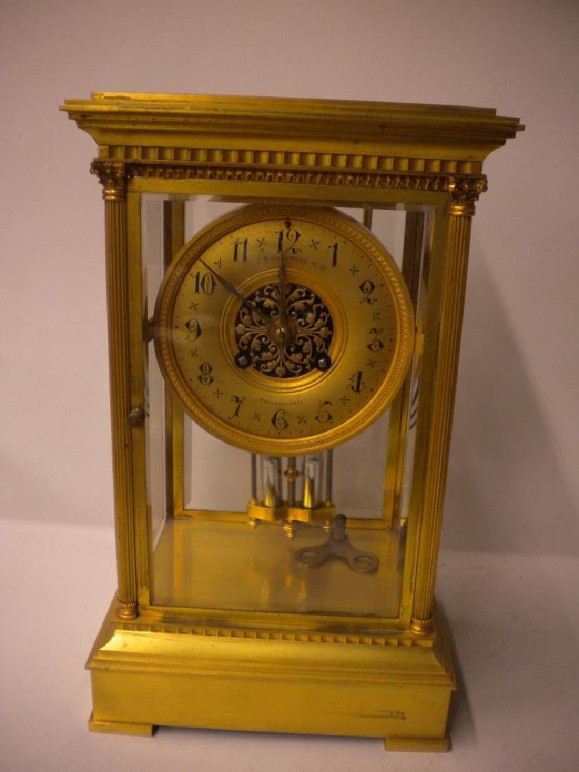 Crystal Regulator Clock: Crystal Regulator Clock, gilt brass and beveled glass, gilt dial with foliate open work center, marked J.E. Caldwell & Co., Phila; time and strike movement, mercury filled pendulum, reeded corner colu