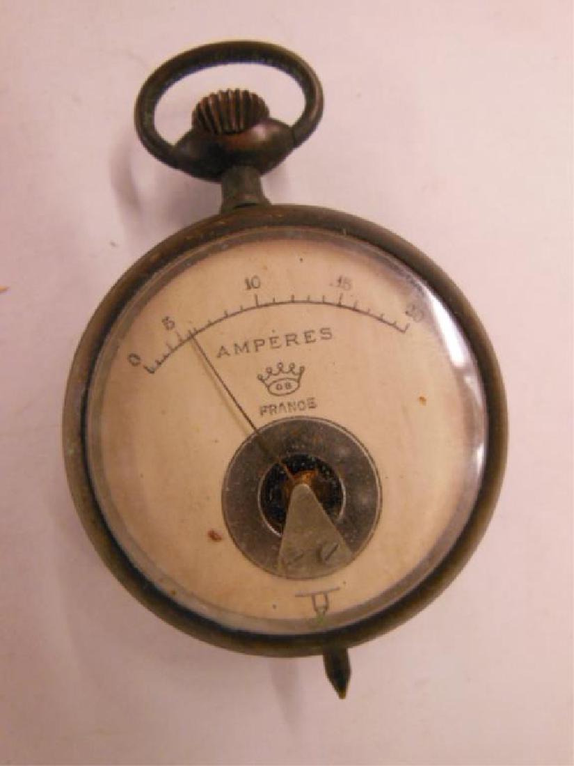 Vintage French Amperes Meter: Vintage French Amperes Meter round, 2 1/4" with glass front, metal case with fob ring at top, needle at bottom, face has needle with gauge from 0-20, crown with FRANCE and makers mark at bottom, mark 