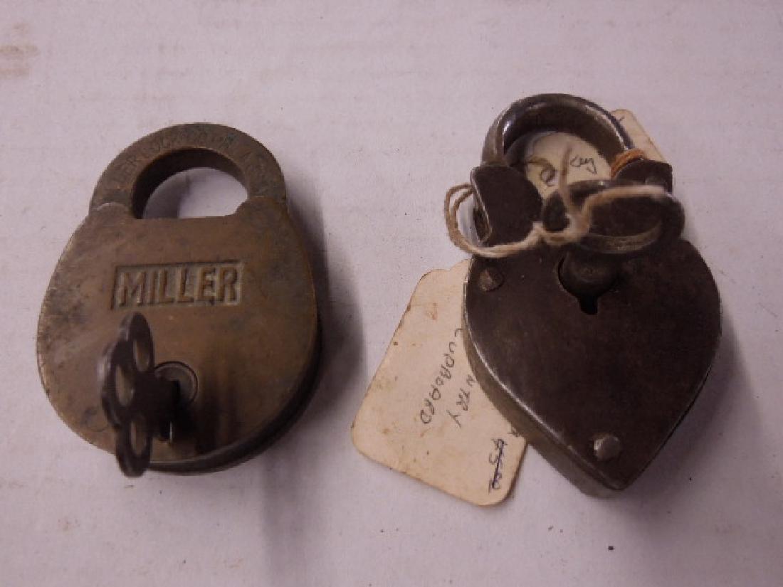 2 Vintage Locks w/Keys: Two Vintage Locks with Keys including: Miller brass lock, 1 3/4" x 2 1/2', no marking on key and Country Cupboard heart shaped lock, tag on key says Country Cupboard Key #6, keys open locks. CONDITION