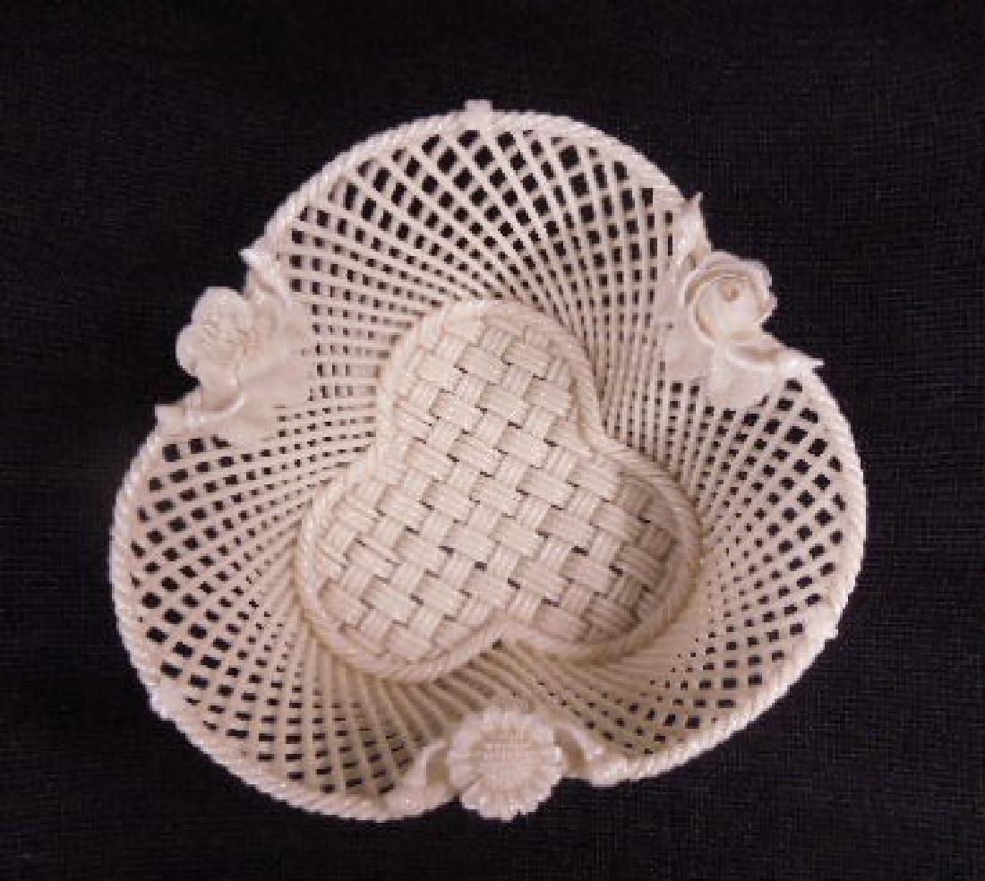 Belleek Fermanagh Woven Bowl: Belleek Fermanagh Woven Bowl, cloves basket weave from with applied floral mounts, early 20th C., 5 1/2" d, 2 1/4"h. CONDITION: Very good, smallest of flake off of two flowers.