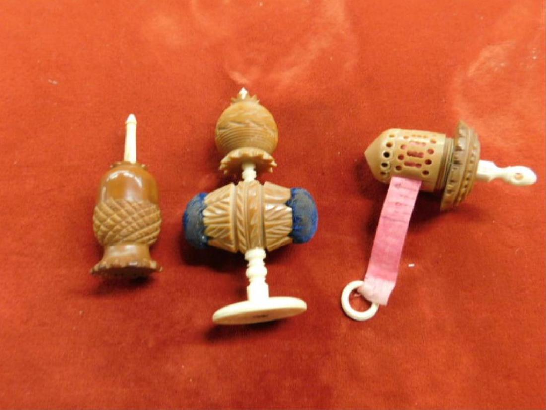 Carved Bone & Nut Sewing Accessories: Early 20th c. carved bone & nut (2) 2 1/2"h tape measures & 3"h pin cushion holder. CONDITION: All have areas with some form of wear from age & usage. Pineapple form measure has chip with loss on base