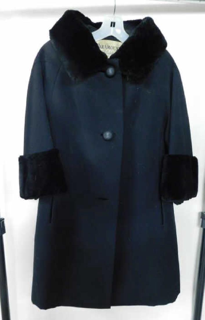 Lady's Serge Coat w/Seal Trim: Lady's serge coat w/seal trim, Paramount of Philadelphia Furs, seal collar & cuffs, triple button, black. 18" across shoulders, 19" arm length, 36-1/2" back length. Condition: very good.