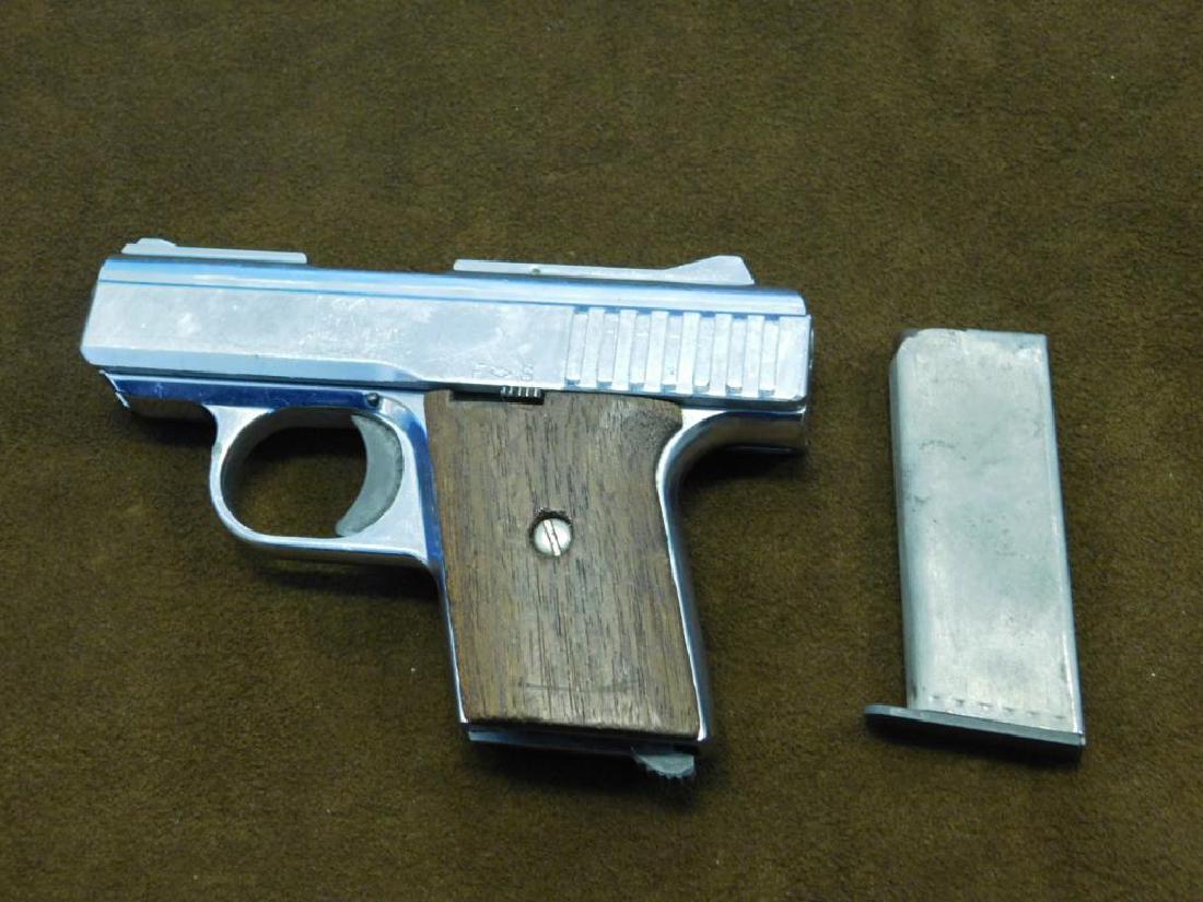 Raven Arms Model P-25: Raven Arms Model P-25, 25 cal. automatic, nickle plated, walnut grips, serial #631047, overall length 4 3/4", barrel 2 7/16", six shot magazine. CONDITION: Scratches and dings, fixable condition.All f
