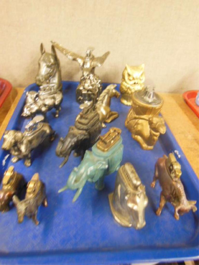 13 Metal Animal Form Table Lighters: 13 Metal Animal Form Table Lighters including; flying eagle on rock, Owl (head lifts off), horse head, sitting camel (with Ronson insert lighter), (2) elephants, (lift arm lighters), smaller elephant 