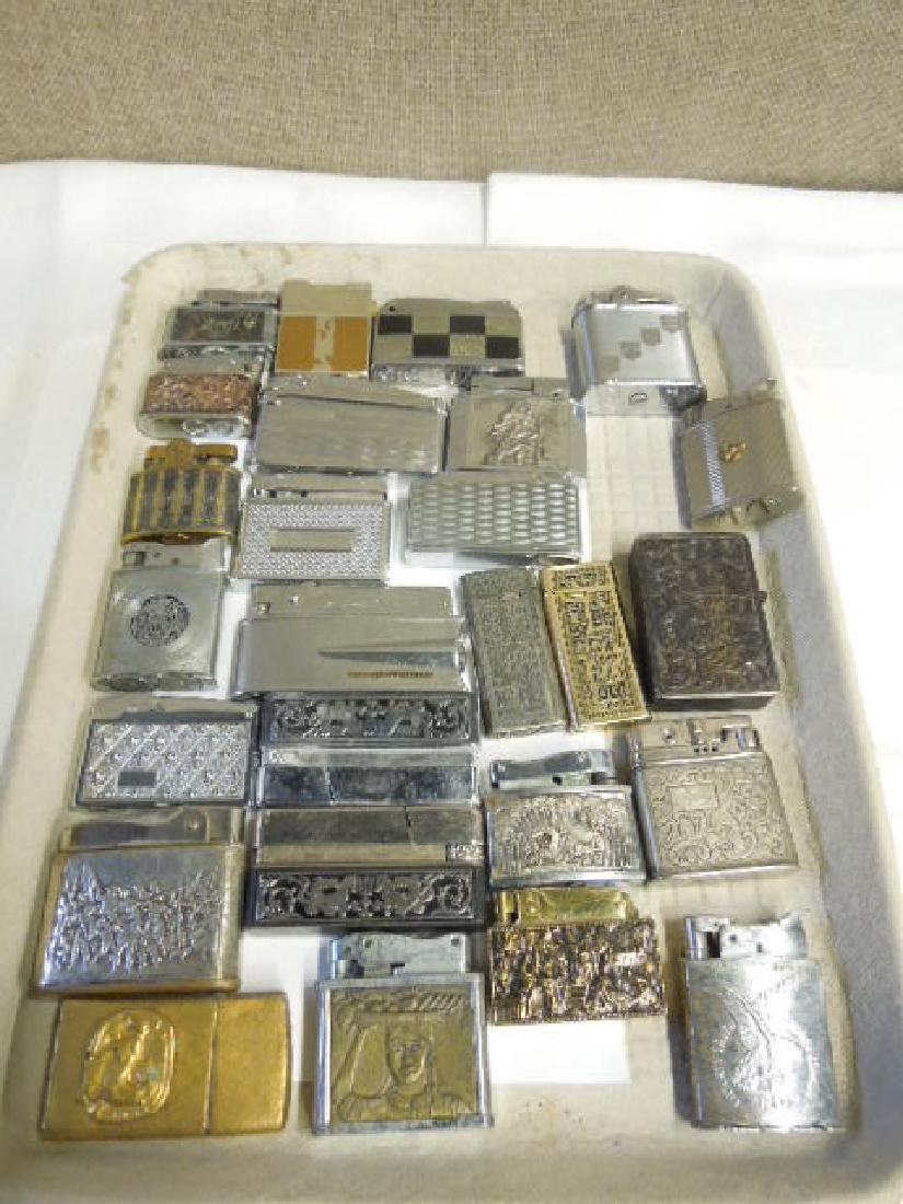 25 Vintage Embossed Pocket Lighters: 25 Vintage Embossed Pocket Lighters, silver and gold tone, most with figural, floral or geometric embossed or etched, Rowenta, Supremer Universe, Evans, Real Lite, Egin American and other plus one 800