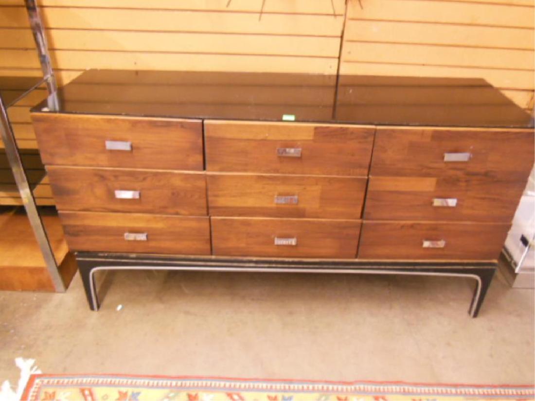 Mid Century Modern Triple Dresser: Mid Century Modern Triple Dresser, black lacquered top over patterned teakwood drawers with chromed metal pulls; black base with high legs and chromed metal trim, 19" x 59" x 32". CONDITION: Scratches