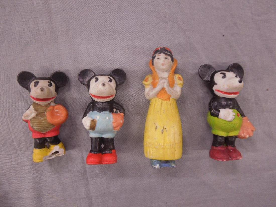 4 Vintage Bisque Disney Figures: 4 Vintage Bisque Disney Figures including: 3 Mickey Mouse baseball players, pitcher, catcher and fielder, all made in Japan, 3 1/8" - 3 3/8"h, plus 1 Snow White figure, 4 1/4"h, all hand painted. COND