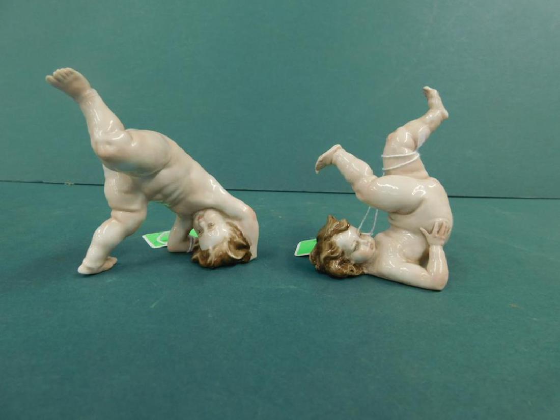 2 B. Merli Capo di Monte Porcelain Figurines: Two B. Merli Capo di Monte Porcelain Figurines of tumbling, nude putti or children, playing by Bruno Merli Capo di Monte marks, signed "B. Merli", height of tallest 3 3/4". CONDITION: Fine.