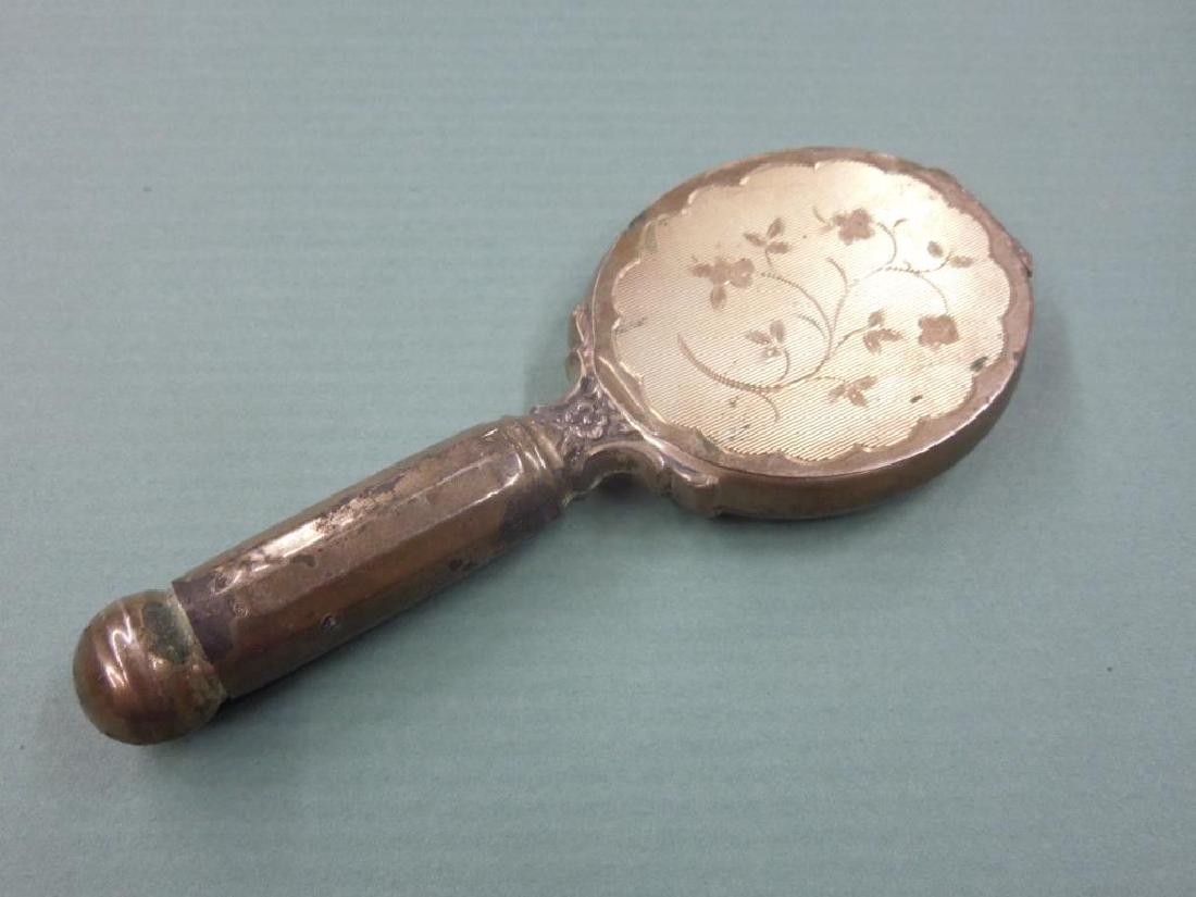 A Novelty Compact: A Novelty Compact in the form of a hand mirror with lipstick in the handle and powder in the head of the mirror, 5 1/4" l. total weight including mirrors 2.56. CONDITION: Some minor dings.