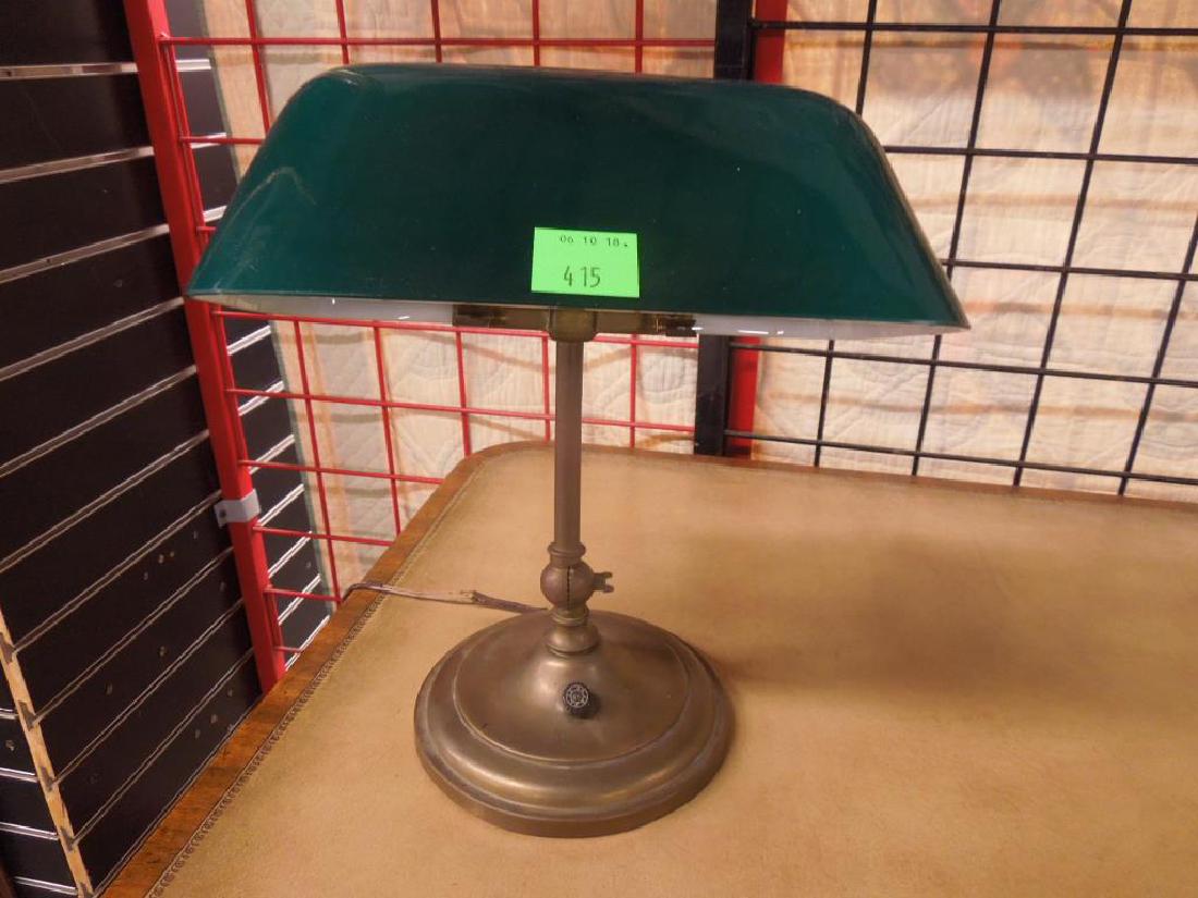 Emeralite Adjustable Bankers Lamp: 2-bulb lamp with brass base and green cased shade. Brass Emeralite tag on clip holding shade.