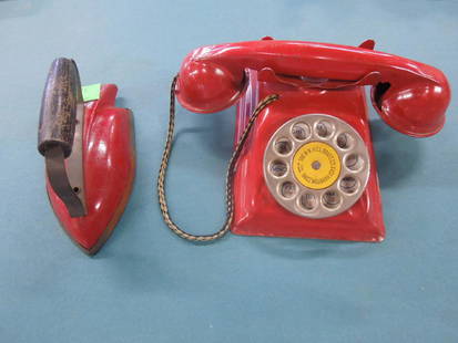 2 Vintage Tin Toys: 2 Vintage Tin Toys including: tin rotary phone, The NN Hill Brass Co., East Hampton, Conn, with ringing bell, 4" x 6" x 2 1/2" h. plus tin toy iron rod with flat metal and round wood handle, 5 1/2". C