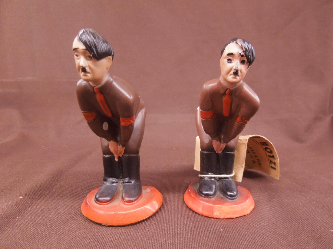 2 Hitler Composition Pin Cushions: Two Hitler Composition Pin Cushions, one with paper tag (missing cushion) Hutzi Notzi "Good Luck to find a pin and stick, tin", 5" each hand painted. CONDITION: Cushioned piece has small inside of arm