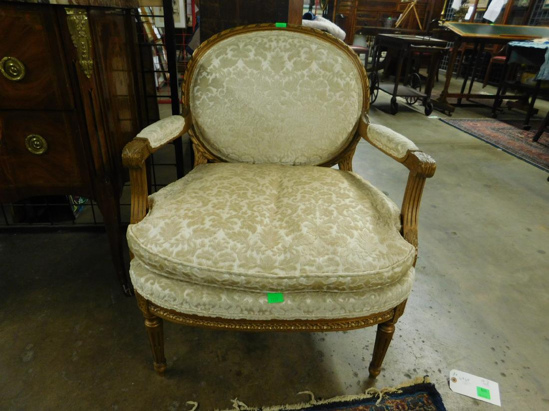 Louis XVI Style Fauteuil: Louis XVI Style Fauteuil, distressed gilt hardwood, rope carved cameo back, feature: acanthus gadroon and rosette carvings, ivory floral brocade upholstery, mid 20th C, 32 1/2"h. CONDITION: Very good,