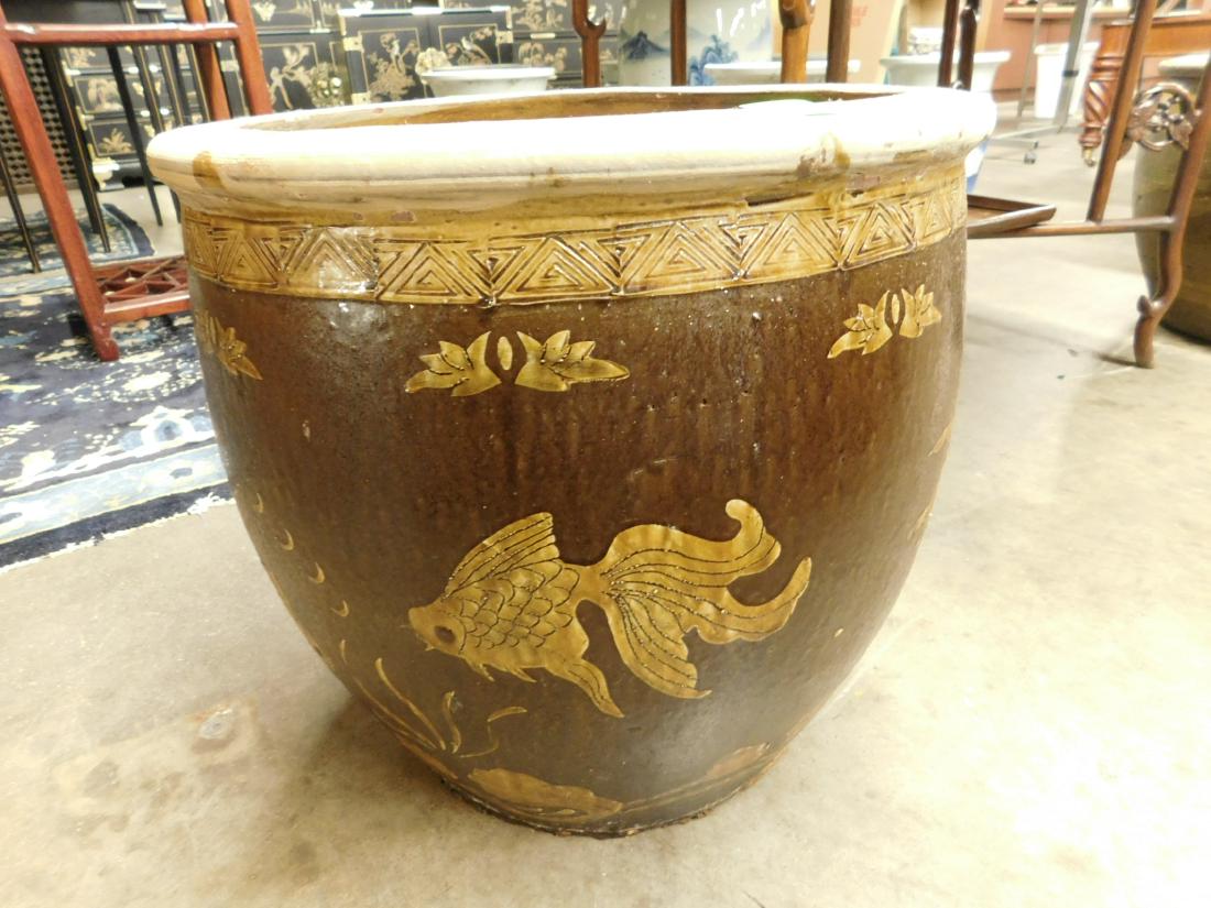 Chinese Stoneware Jardiniere: Chinese Stoneware Jardiniere, brown glazed with Koi fish and leaf motifs, mid 20th C, 17"h, 18"d. CONDITION: Good, areas of small chipping and roughness along base rim.