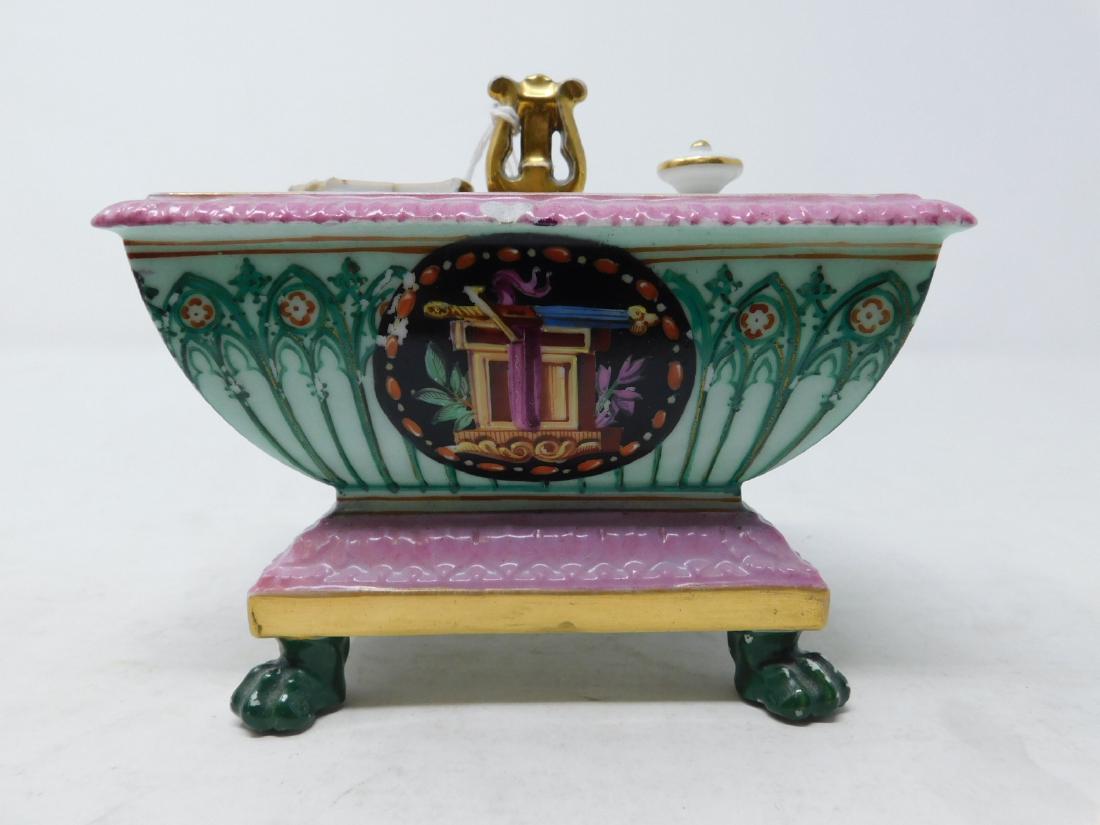 Vieux Paris Porcelain Gothic Revival Inkwell: Vieux Paris Porcelain Gothic Revival Inkwell: An Old Paris porcelain inkwell in the form of a footed sarcophagus hand-painted with Gothic Revival style tracery around a central medallion of a sword on