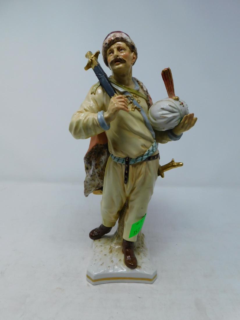 Antique KPM Porcelain Turkish Figure: Antique KPM Porcelain Turkish Figure : A fine, large figurine of an Ottoman solider wearing a peach-colored outfit of pants and a blouse, over which he's wearing a fur-lined cape, with a fur-lined hat